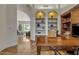 Charming home office with custom built-ins, decorative shelves, and an arched doorway at 4222 E Brown Rd # 31, Mesa, AZ 85205