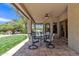 Covered patio features ceiling fan, outdoor seating, and beautiful backyard views at 4222 E Brown Rd # 31, Mesa, AZ 85205