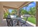 Relaxing covered patio with an outdoor table and view of the sparkling pool at 4222 E Brown Rd # 31, Mesa, AZ 85205