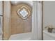 Shower features decorative tile, a unique window, a shower curtain, and updated fixtures at 4222 E Brown Rd # 31, Mesa, AZ 85205