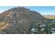 Aerial view of rocky mountain and surrounding homes at 11568 E Whispering Wind Dr, Scottsdale, AZ 85255