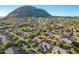 Aerial perspective of community, showcasing homes and mountain views at 11568 E Whispering Wind Dr, Scottsdale, AZ 85255