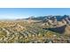 Aerial view of homes and mountains in the background at 11568 E Whispering Wind Dr, Scottsdale, AZ 85255