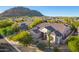 Single-story house with tile roof, desert landscaping, and mountain views at 11568 E Whispering Wind Dr, Scottsdale, AZ 85255
