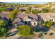 Single-story house with a tile roof, two-car garage, and landscaped front yard at 11568 E Whispering Wind Dr, Scottsdale, AZ 85255