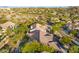 Aerial view of home with pool and landscaping, mountain backdrop at 11568 E Whispering Wind Dr, Scottsdale, AZ 85255