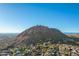 Aerial view showcasing a dramatic mountain backdrop and community at 11568 E Whispering Wind Dr, Scottsdale, AZ 85255