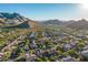 Aerial view of a luxury community nestled in the mountains with stunning desert landscape at 11568 E Whispering Wind Dr, Scottsdale, AZ 85255