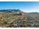 Aerial view showcasing a neighborhood's beautiful homes and mountain backdrop at 11568 E Whispering Wind Dr, Scottsdale, AZ 85255