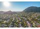 Aerial view of neighborhood with mountain backdrop and homes at 11568 E Whispering Wind Dr, Scottsdale, AZ 85255