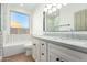 Modern bathroom with double vanity and a large mirror at 11568 E Whispering Wind Dr, Scottsdale, AZ 85255