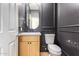 Modern bathroom with light wood vanity and dark walls at 11568 E Whispering Wind Dr, Scottsdale, AZ 85255