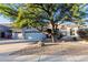 Two-story home with a large tree and gravel landscaping at 11568 E Whispering Wind Dr, Scottsdale, AZ 85255