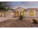 Beautiful desert home with stucco exterior, neutral color palette, and mature landscaping at 11568 E Whispering Wind Dr, Scottsdale, AZ 85255