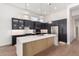 Modern kitchen with dark cabinetry, marble countertops, and a large island at 11568 E Whispering Wind Dr, Scottsdale, AZ 85255