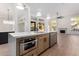 Eat-in kitchen with island, stainless steel appliances and hardwood floors at 11568 E Whispering Wind Dr, Scottsdale, AZ 85255