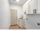 Laundry room with sink, cabinets and vinyl flooring at 11568 E Whispering Wind Dr, Scottsdale, AZ 85255