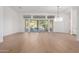 Spacious living area with large windows, hardwood floors, and a chandelier at 11568 E Whispering Wind Dr, Scottsdale, AZ 85255