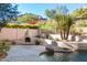Relaxing pool area with a fire pit and mountain views at 11568 E Whispering Wind Dr, Scottsdale, AZ 85255