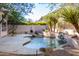Private pool and waterfall feature in backyard at 11568 E Whispering Wind Dr, Scottsdale, AZ 85255