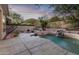 Inviting pool with waterfall feature and patio area at 11568 E Whispering Wind Dr, Scottsdale, AZ 85255