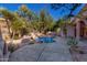 Serene backyard oasis featuring a sparkling pool, flagstone patio, and desert landscaping at 11568 E Whispering Wind Dr, Scottsdale, AZ 85255