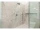 Spa-like shower with marble tile and glass enclosure at 11568 E Whispering Wind Dr, Scottsdale, AZ 85255