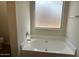 Bright bathroom featuring a soaking tub with tile surround at 3922 N Creosote Ct, Casa Grande, AZ 85122