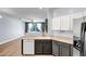 Modern kitchen view that features stainless steel appliances, neutral countertops, and an open layout at 4512 W Stoneman Dr, Anthem, AZ 85086