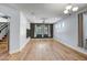 Bright living room with hardwood floors, stylish lighting, and large windows for natural light at 4512 W Stoneman Dr, Anthem, AZ 85086