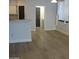 Spacious living room with wood floors leading to kitchen and laundry room at 4512 W Stoneman Dr, Anthem, AZ 85086