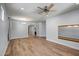 Spacious living area with hardwood floors, modern lighting, and a view into other rooms at 4512 W Stoneman Dr, Anthem, AZ 85086