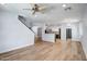 Open-concept living area with hardwood floors, connecting to the kitchen and other parts of the house at 4512 W Stoneman Dr, Anthem, AZ 85086
