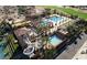 Aerial view of a multi-pool community center with a slide and shaded cabanas at 6429 S Honor Ct, Gilbert, AZ 85298