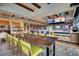 Expansive community dining room with a long wooden table and multiple TVs for entertainment at 6429 S Honor Ct, Gilbert, AZ 85298