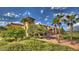 Lush landscaping surrounds this building, showcasing meticulously maintained grounds and mature palm trees at 6429 S Honor Ct, Gilbert, AZ 85298