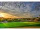 Well-manicured golf course with lush green fairway and a red flag on a sunny day at 6429 S Honor Ct, Gilbert, AZ 85298
