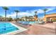 Inviting outdoor pool area with lounge chairs and tropical palm trees at 6429 S Honor Ct, Gilbert, AZ 85298