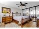 Spacious bedroom with bamboo bed frame, mirror, and wood dresser at 7401 N Scottsdale Rd # 3, Paradise Valley, AZ 85253