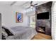 Bedroom with fireplace, large TV, and comfortable bed at 7401 N Scottsdale Rd # 3, Paradise Valley, AZ 85253