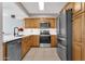 Modern kitchen with wood cabinets and stainless steel appliances at 7401 N Scottsdale Rd # 3, Paradise Valley, AZ 85253