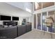 Open living area with large sectional sofa and access to backyard at 7401 N Scottsdale Rd # 3, Paradise Valley, AZ 85253