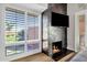 Living room with fireplace, large windows, and golf course view at 7401 N Scottsdale Rd # 3, Paradise Valley, AZ 85253
