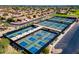 Aerial view of pickleball courts within a community, with multiple courts, surrounding houses, and green spaces at 19926 N Organ Pipe Dr, Surprise, AZ 85374