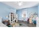 Bright bedroom with blue walls, white trim, wood-look floors, and a ceiling fan at 38 W Lynwood St, Phoenix, AZ 85003