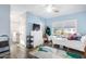 Bright bedroom with blue walls, white trim, wood-look floors, and a ceiling fan at 38 W Lynwood St, Phoenix, AZ 85003