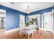 Elegant dining room with rich blue walls, hardwood floors, and stylish decor at 38 W Lynwood St, Phoenix, AZ 85003