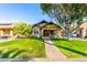 Charming bungalow with a well-manicured lawn and mature landscaping at 38 W Lynwood St, Phoenix, AZ 85003