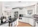 Bright eat-in kitchen with white cabinets, stainless appliances, and hardwood flooring at 38 W Lynwood St, Phoenix, AZ 85003