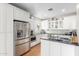 Bright kitchen features stainless steel appliances, white cabinets, and hardwood flooring at 38 W Lynwood St, Phoenix, AZ 85003